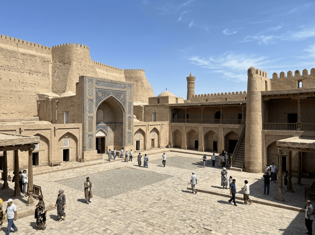 Spacious courtyard of a historic citadel with people walking and ancient fortress walls
