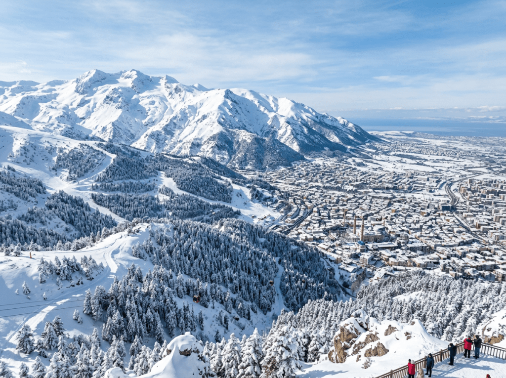 Snow-covered ski resort town beneath towering mountains and forested slopes